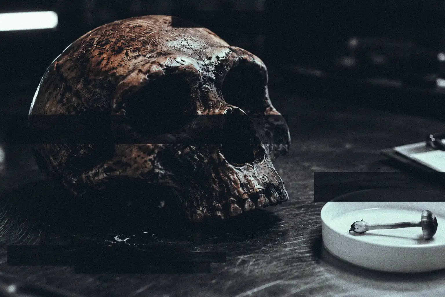 An ancient hominin skull resting beside a psilocybin mushroom in a laboratory petri dish, partially obscured by black redaction bars on a dark metal surface.