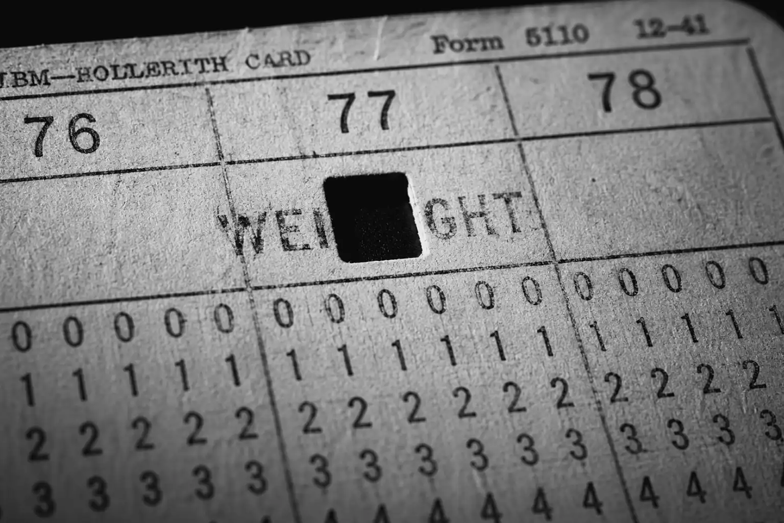 Close-up illustration of a 1940s IBM Hollerith punch card. A fresh hole is punched through columns 76 to 78, directly over the pre-printed word 'WEIGHT', demonstrating the physical data overwrite ordered in TM-12-305.